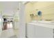 Convenient laundry room with washer, dryer, and storage shelves at 4633 Lightkeepers Way # 5-C, Little River, SC 29566
