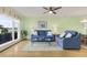Light-filled living room featuring hardwood floors and two blue sofas at 4633 Lightkeepers Way # 5-C, Little River, SC 29566