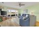 Living room with hardwood floors, gray sofa, and water views at 4633 Lightkeepers Way # 5-C, Little River, SC 29566
