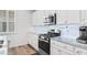 Kitchen with white cabinets, granite countertops, and stainless steel appliances at 4739 Cloisters Ln., Myrtle Beach, SC 29577
