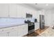 Kitchen with white cabinets, granite countertops, and stainless steel appliances at 4739 Cloisters Ln., Myrtle Beach, SC 29577