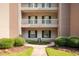 Exterior view of building with landscaping and walkway at 598 Blue Stem Dr. # 52D, Pawleys Island, SC 29585