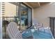 Private balcony with chairs and rug, offering partial ocean view at 7500 Ocean Blvd. N # 6010, Myrtle Beach, SC 29572