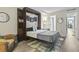 Bedroom with a queen bed, built in shelving, and a murphy bed at 7500 Ocean Blvd. N # 6010, Myrtle Beach, SC 29572