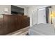 Bedroom with a murphy bed and large TV at 7500 Ocean Blvd. N # 6010, Myrtle Beach, SC 29572