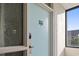 Building entry with light teal door and window looking out to landscaping at 7500 Ocean Blvd. N # 6010, Myrtle Beach, SC 29572