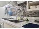 Clean white kitchen features a mosaic backsplash and modern fixtures at 7500 Ocean Blvd. N # 6010, Myrtle Beach, SC 29572