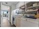Small galley kitchen with white cabinets, mosaic backsplash, and modern appliances at 7500 Ocean Blvd. N # 6010, Myrtle Beach, SC 29572