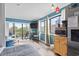 Open living space with teal walls, balcony access, and a kitchen view at 7500 Ocean Blvd. N # 6010, Myrtle Beach, SC 29572