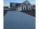 Two-story home with gray siding, three-car garage, and yellow door at 1005 Gold Dew Way, Myrtle Beach, SC 29579