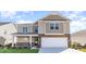 Two-story house with beige siding, stone accents, and a two-car garage at 1106 Barrington Way, Conway, SC 29526