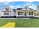 White farmhouse exterior with front porch and landscaped lawn at 320 Bunny Trail Ct., Myrtle Beach, SC 29588