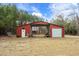 Red metal garage with large roll-up doors at 3480 Highway 348, Loris, SC 29569