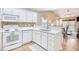 White kitchen with white appliances and tile backsplash at 400 Blue Stem Dr. # 60-E, Pawleys Island, SC 29585