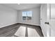 Bright bedroom with wood-look floors and large window at 4071 Nelson Rd., Little River, SC 29566