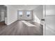 Main bedroom with two windows and grey vinyl plank flooring at 4071 Nelson Rd., Little River, SC 29566