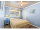 Light blue bedroom with a double bed and ceiling fan at 431 28Th St. S, Sunset Beach, NC 28468