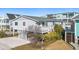 Beach house with gray siding, ample parking, and mature landscaping at 431 28Th St. S, Sunset Beach, NC 28468