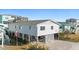 Elevated beach house with gray siding, spacious deck, and parking area at 431 28Th St. S, Sunset Beach, NC 28468