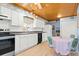 White kitchen cabinets, breakfast nook, and wood ceiling at 431 28Th St. S, Sunset Beach, NC 28468
