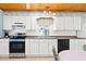 Kitchen with white cabinets, stainless steel appliances, and wood ceiling at 431 28Th St. S, Sunset Beach, NC 28468