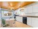 Charming kitchen with white cabinets, tiled floor and breakfast nook at 431 28Th St. S, Sunset Beach, NC 28468