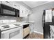 White cabinets, black appliances, and a built-in microwave at 609 Hillside Dr. S # D-17, North Myrtle Beach, SC 29582