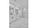 Modern bathroom boasts double vanity, marble floors, and a frameless glass shower at 6703 Ocean Breeze Loop, Myrtle Beach, SC 29577