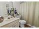 Well-lit bathroom with a toilet and shower at 702 Plantation Dr., Surfside Beach, SC 29575