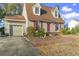 Front view of a house with a garage and landscaping at 702 Plantation Dr., Surfside Beach, SC 29575