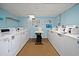 Well-lit laundry room featuring multiple washers and dryers for residents at 7509 N Ocean Blvd. # 404, Myrtle Beach, SC 29572