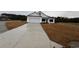 White house with a two-car garage and a long concrete driveway at Tbb 20 Privetts Rd., Conway, SC 29526