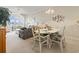 Charming dining area with glass-top table and white chairs at 4519 N Plantation Dr. # X-9, Little River, SC 29566