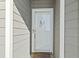 White front door with glass panel and wreath at 4519 N Plantation Dr. # X-9, Little River, SC 29566