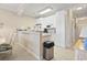 White kitchen with ample cabinet space and view of hallway at 4519 N Plantation Dr. # X-9, Little River, SC 29566
