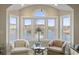 Bright living room with water views and two comfy chairs at 4519 N Plantation Dr. # X-9, Little River, SC 29566