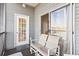 Screened balcony with two chairs and access to the condo at 4519 N Plantation Dr. # X-9, Little River, SC 29566