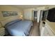 Main bedroom with a king-size bed and access to bathroom at 501 S Ocean Blvd. # 601, North Myrtle Beach, SC 29582