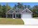 Two-story house with gray siding, white garage door, and landscaped lawn at Tbd 15 Mineral Springs Rd., Conway, SC 29527