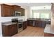 Modern kitchen with dark wood cabinets, granite countertops and stainless steel appliances at Tbd 15 Mineral Springs Rd., Conway, SC 29527