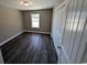 Well-lit bedroom featuring dark laminate floors and double-door closet at Tbd20 Casey Dr., Nichols, SC 29581
