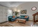 Living Room with teal couches and a wood coffee table at 305 21St Ave. S # 116, Myrtle Beach, SC 29577