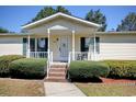 House exterior features a covered porch and brick steps at 894 S Marlin Circle, Murrells Inlet, SC 29576