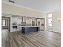Open concept kitchen features a large island, stainless steel appliances, and white cabinets at 239 Bluestem Loop, Little River, SC 29566