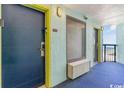 Hotel hallway with teal walls and ocean view at 6804 N Ocean Blvd. # 1233, Myrtle Beach, SC 29572