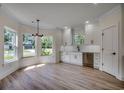 Eat-in kitchen with white cabinets, stainless steel appliances, and hardwood floors at 209 Brush Ct., Little River, SC 29566