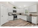 Modern kitchen with white cabinets and stainless steel appliances at 2815 Biscane Ct., Conway, SC 29527