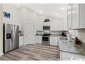 Modern kitchen with white cabinets and granite countertops at 2815 Biscane Ct., Conway, SC 29527