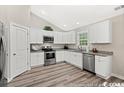 Modern kitchen with white cabinets and granite countertops at 2815 Biscane Ct., Conway, SC 29527