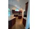 Spacious kitchen with dark wood cabinets and an island at 333 William St., Myrtle Beach, SC 29577